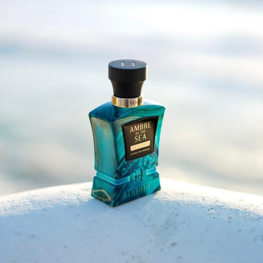 Ambre of the Sea perfume; a rich amber combined with refreshing marine notes, housed in an elegant blue bottle by Habibi New York.