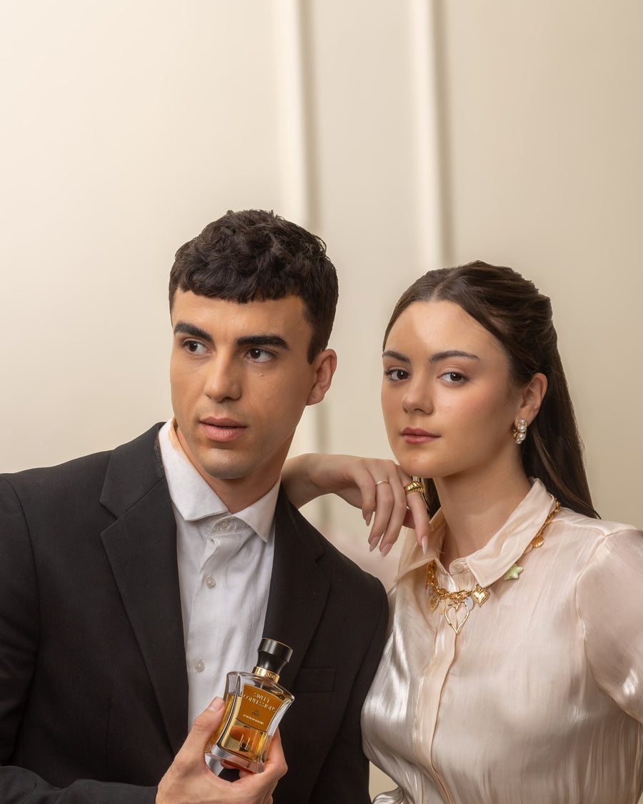A couple standing together, the man holding a HABIBI bottle