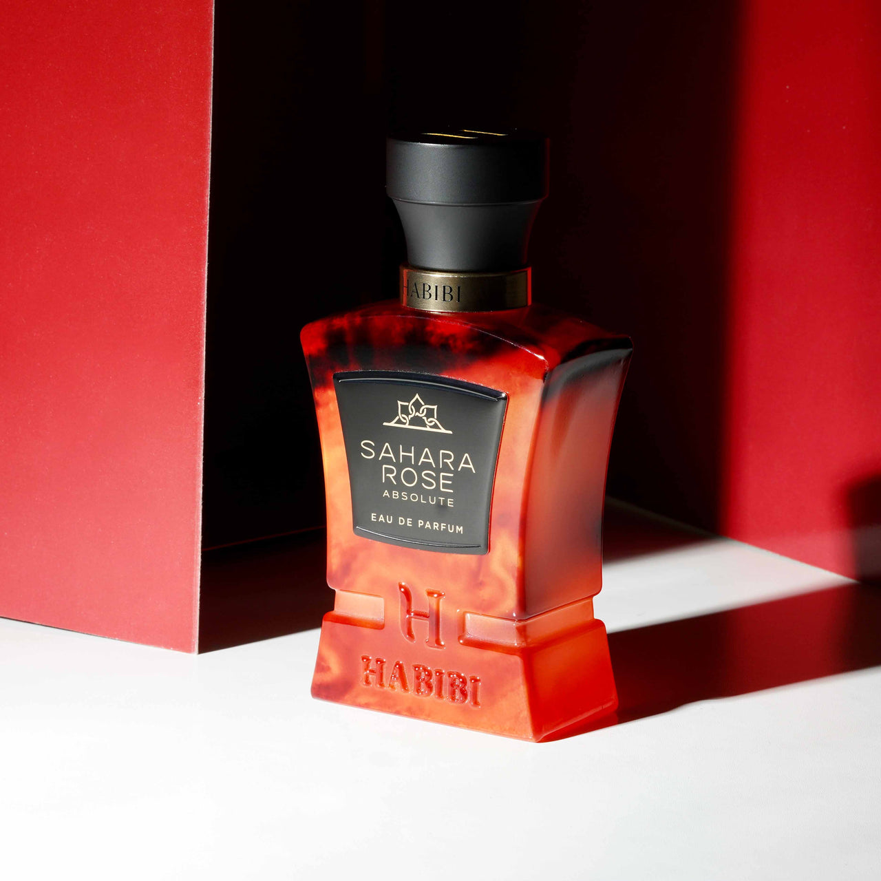 Habibi New York's Sahara Rose fragrance in a red bottle.